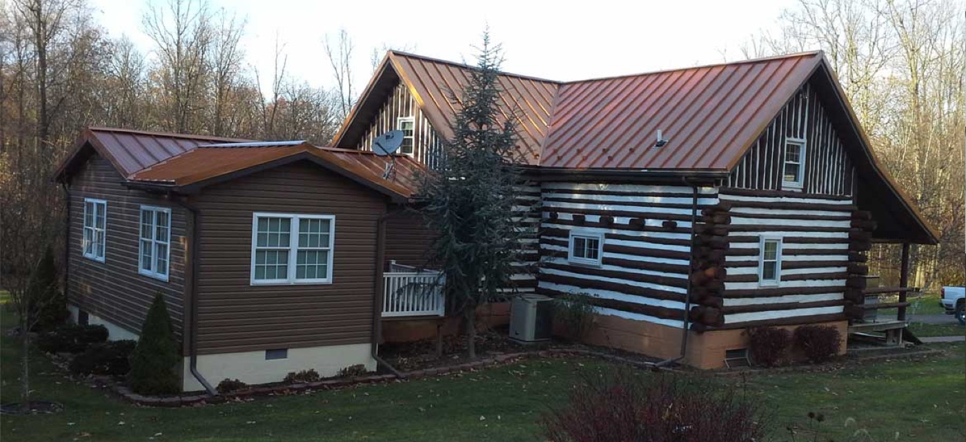 Copper standing seam roof on a log home